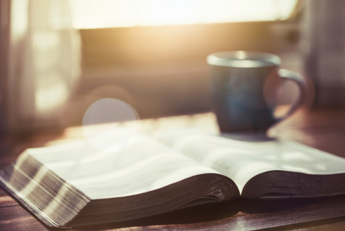 Open Bible with coffee mug